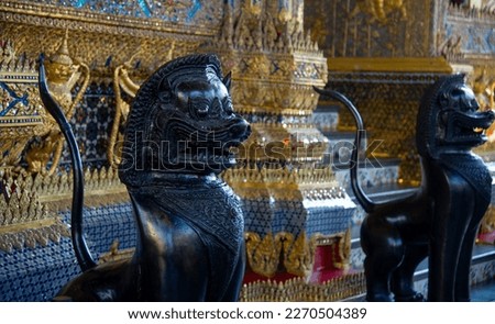 Wat Phra Kaew Bangkok temple inside with two black lions standing guard
