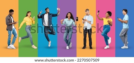 Glad excited millennial and adult diverse people in casual take selfie, show smartphone, chatting, isolated on colorful background, studio, panorama, full length. Device, app, sale and great news Royalty-Free Stock Photo #2270507509