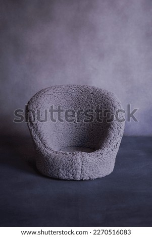 Baby sofa from sheep's hair with a dark background