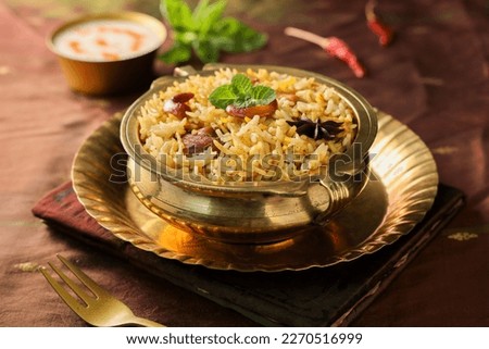 Chicken biryani Spicy Indian Malabar biryani Hyderabadi biryani. Dum Biriyani pulao golden bowl Kerala India Sri Lanka Pakistan. Basmati rice mixed rice dish with meat curry Ramadan Kareem Eid Royalty-Free Stock Photo #2270516999