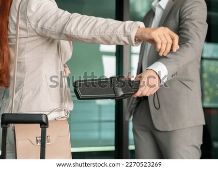 Security male officer using metal detector on female passenger at airport boarding gate. Airport travel and security concept. Royalty-Free Stock Photo #2270523269