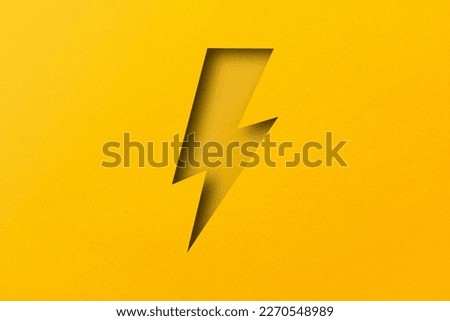 yellow paper cut into holes Lightning bolts are overlaid with light and shadow. Royalty-Free Stock Photo #2270548989
