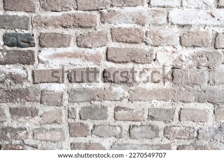 Stone wall texture with red bricks, close-up. Brick wall background for publication, design, poster, calendar, post, screensaver, wallpaper, postcard, banner, cover, website. High quality photography