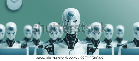 Many identical AI robots sitting at desk in the office and working with computers, one robot is looking at camera: artificial intelligence and robotization effects on employment Royalty-Free Stock Photo #2270550849