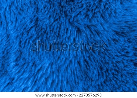 Blue background with long fur texture with space for text.