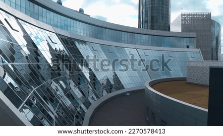 Modern building with glass windows and reflection. Stock footage. Modern architecture of glass buildings for offices or cultural museums. Beautiful reflection of buildings and sky in windows of modern