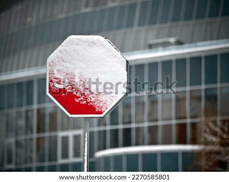 Road sign "Stop" covered with snow