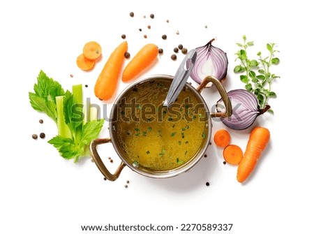 Chicken broth, stock or bouillon with vegetables isolated on white background, top view