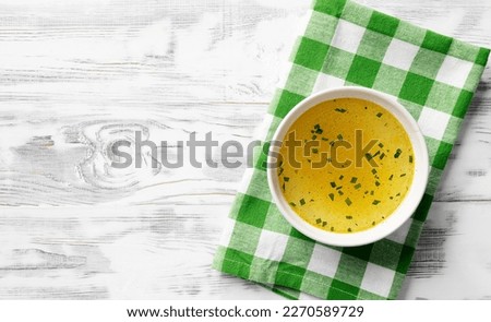 Chicken broth, stock or bouillon with vegetables, top view