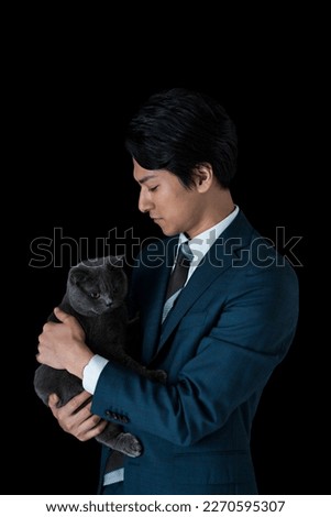 Image of a man holding a cat