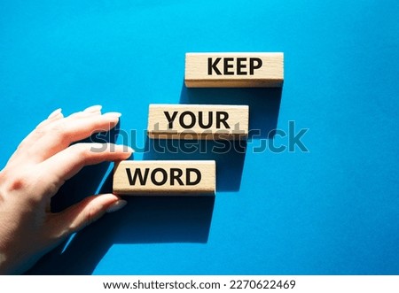 Keep your word symbol. Wooden blocks with words Keep your word. Beautiful blue background. Businessman hand. Business and Keep your word concept. Copy space.