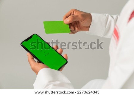 A man gives a card to a woman, and a woman holding up a card