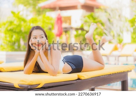 Portrait beautiful young asian woman relax smile leisure around outdoor swimming pool in hotel resort on vacation travel