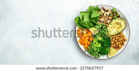 vegetable vegetarian buddha bowl avocado, mushrooms, broccoli, spinach, chickpeas, pumpkin on a light background. Long banner format. top view.