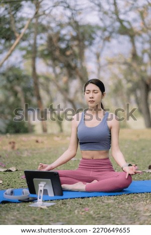 Young woman asian practicing breathing exercise at Park near the house.