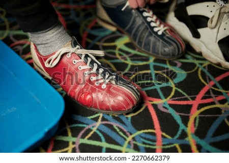 bowling shoes. Young man lacing his shoes in bowling club. closeup