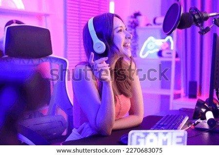 Young Asian Pretty woman Pro Gamer have live streaming , singing  and chatting  with her fans  at home