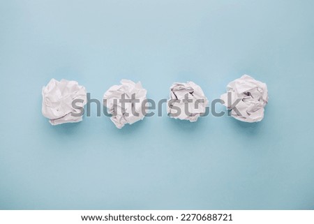 Crumpled paper balls on blue background. Brain storming and idea concept