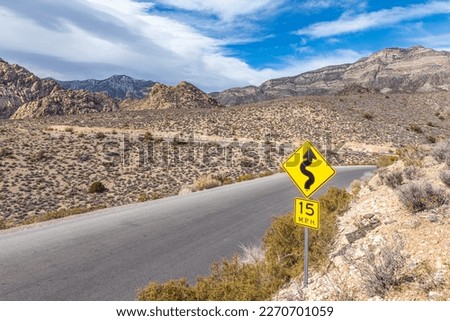 A warning sign along the winding roads at Red Rock Canyon conservation wilderness in Las Vegas, Nevada.
