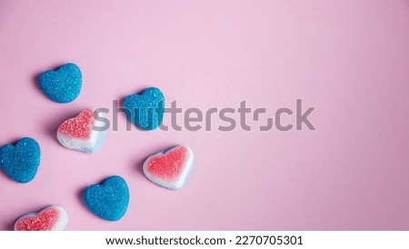Colorful heart shaped candies on pink background with copy space. Royalty-Free Stock Photo #2270705301