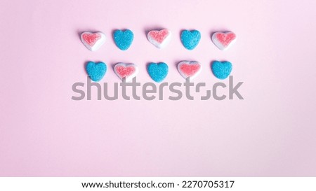 Colorful heart shaped candies on pink background with copy space. Royalty-Free Stock Photo #2270705317