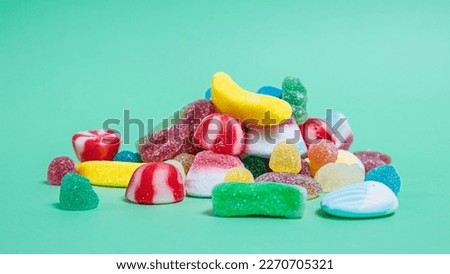 Colorful candies on green background. Top view with copy space Royalty-Free Stock Photo #2270705321