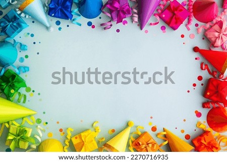 Colorful rainbow birthday party border frame background with party hats, birthday gifts and streamers