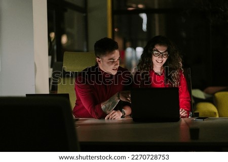 Lovely business couple working late night at the office and having fun conversation. Close up photo