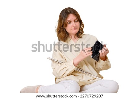 Woman musician with empty wallet no money at home on sofa in living room, isolated on a white background