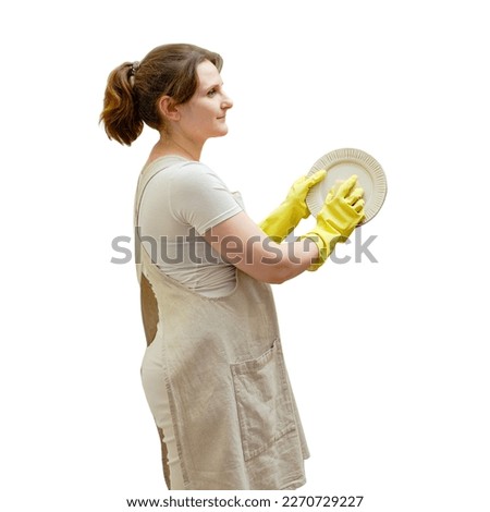A woman washes dishes with a sponge in the sink while cleaning the home kitchen, isolated on a white background