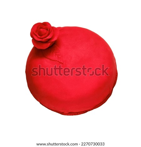 Red cake covered with marzepan or mastic and decorated with a flower, isolated on a white background