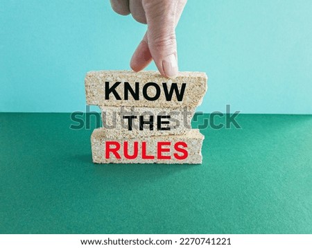 Know the rules symbol. Brick blocks with words Know the rules. Beautiful blue background, green table. Business and Know the rules concept. Copy space