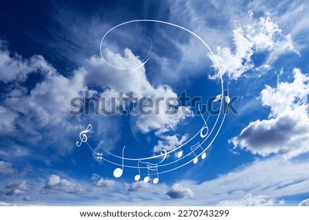 Treble clef and swirly staff with musical notes against sky