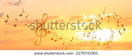 Treble clef and swirly staff with musical notes against sunset sky, banner design Royalty-Free Stock Photo #2270743301