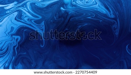 Ink water. Fluid mix. Marble texture. Ocean swirl. Dark blue color liquid oil paint blend wave abstract art background with free space.