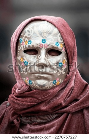 Masked person at venetian carnival