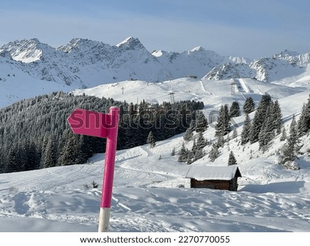 Hiking markings and orientation signs with signposts for navigating in the idyllic winter ambience above the tourist resort of Arosa in the Swiss Alps - Canton of Grisons, Switzerland (Schweiz)