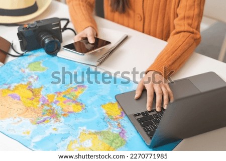 Travel planning, vacation, holiday trip concept, asian young tourist woman hand take note, check list using laptop searching information booking ticket or hotel online, preparation for journey trip. Royalty-Free Stock Photo #2270771985