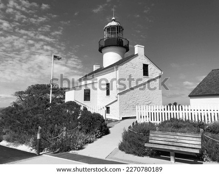 Historic Lighthouse with the American Flag blowing in the breeze