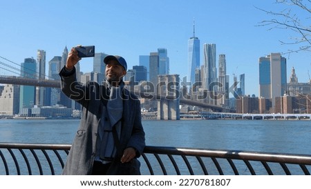 Americam Man takes photos of the Manhattan Skyline - travel photography