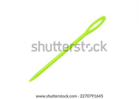 Green plastic yarn needle isolated on white background. Large-Eye  Weaving Sewing Knitting needle Royalty-Free Stock Photo #2270791645