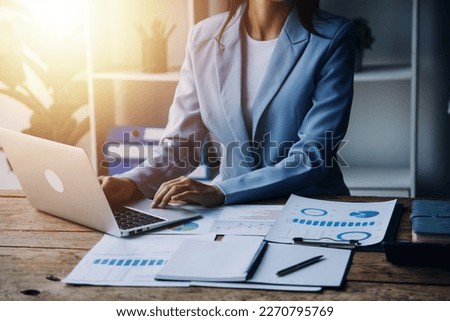 Businesswoman or accountant working Financial investment on calculator, calculate, analyze business and marketing growth on financial document data graph, Accounting, Economic, commercial concept.