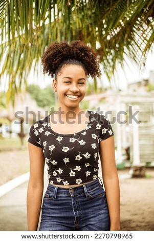 Vertical portrait of young african girl student outdoors.
