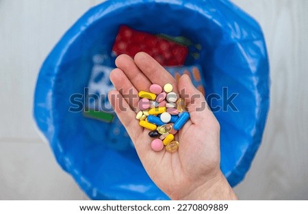 Throw tablets in the trash. Selective focus. Blue. Royalty-Free Stock Photo #2270809889