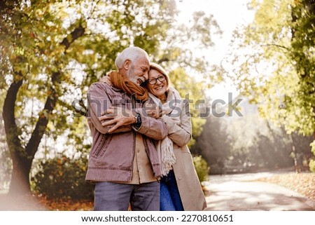 Portrait of a beautiful senior couple in the public park. Early retirement