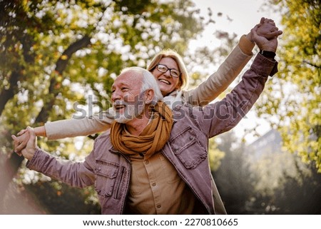 Portrait of a beautiful senior couple in the public park. Early retirement Royalty-Free Stock Photo #2270810665