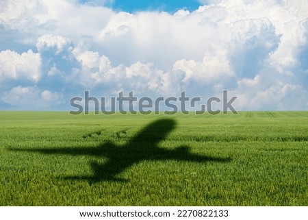 Shadow of the plane on the agricultural field. Concept of decarbonization and biofuel Royalty-Free Stock Photo #2270822133