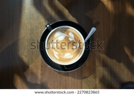 A flatlay picture of flat white coffee art