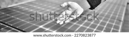 best selling banner in black and white patterns. German craftsman shows Hand, engineer and solar panel in construction for renewable energy, electricity or technology under ecological and economic asp Royalty-Free Stock Photo #2270823877