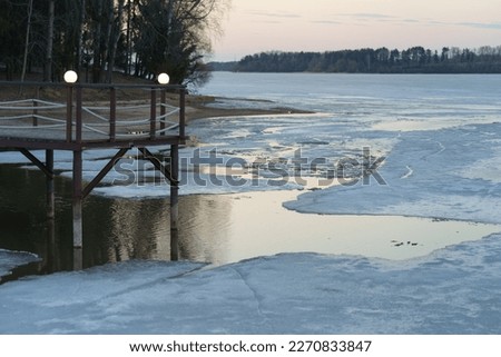 Photography of coming spring, Russian countryside. Blue and pink sunset. Beautiful view. It 's getting warmer. Wooden bridge. Concept of the beauty in nature. 
